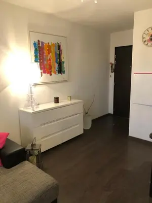 a living room with a dresser and a painting on the wall at Joli T2 récent 'Le VIVALDI' in Ajaccio