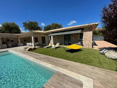 a backyard with a pool and a house at Villa Poggio Rosso - Pool-House & Piscine chauffée in Sainte-Lucie de Porto-Vecchio