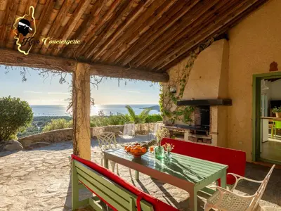 a table and chairs on the patio of a house at Villa Acciagina 10 pers PISCINE VUE MER PINARELLO Climatisée in Pinarellu