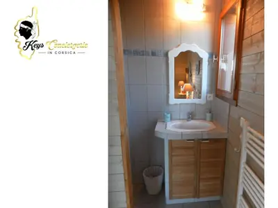 a bathroom with a sink and a mirror at Dormir à Porto Vecchio (Trinité) in Porto-Vecchio