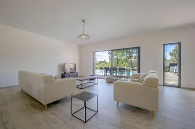 a living room with two couches and a table at Maison Del Onda in Lecci