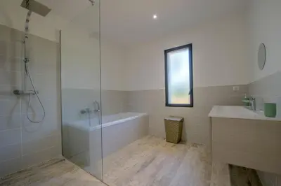 a bathroom with a shower and a tub and a sink at Maison Del Onda in Lecci