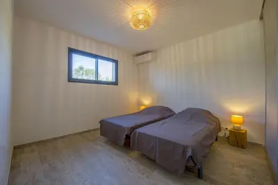 a bedroom with two beds and a window at Maison Del Onda in Lecci