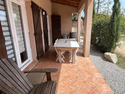 a patio with a table and two chairs on a porch at Rez de villa bordure Ajaccio in Ajaccio