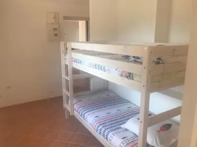 a room with two bunk beds in a room at Rez de villa bordure Ajaccio in Ajaccio