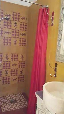 a bathroom with a red shower curtain and a sink at Villa Primavera in Galeria