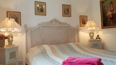 a bedroom with a white bed with two lamps at Villa Primavera in Galeria