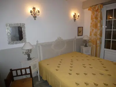 a bedroom with a bed with a yellow bedspread at Villa Primavera in Galeria