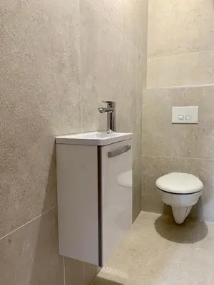 a bathroom with a toilet and a sink at CASA CITADELLA Bonifacio in Bonifacio