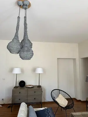 a living room with two lights hanging from the ceiling at CASA CITADELLA Bonifacio in Bonifacio
