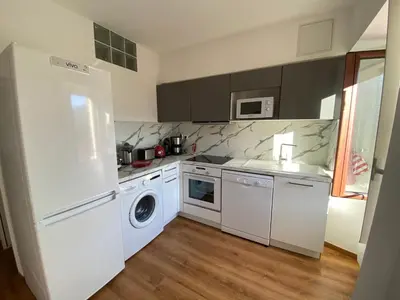 a kitchen with a white refrigerator and a dishwasher at FUNTANA NOVA in Piana