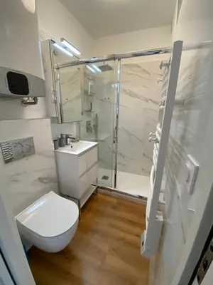 a bathroom with a shower and a toilet and a sink at FUNTANA NOVA in Piana