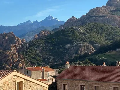 a view of a mountain with houses and mountains at FUNTANA NOVA in Piana