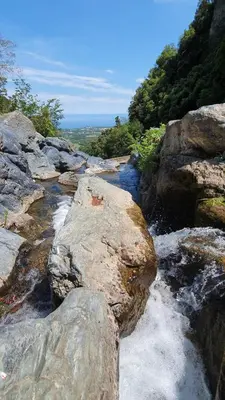 a stream of water with rocks in a river at Maison U nidu à 500m de la mer in Cervione