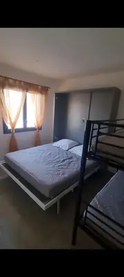 a bedroom with two bunk beds and a window at Maison U nidu à 500m de la mer in Cervione