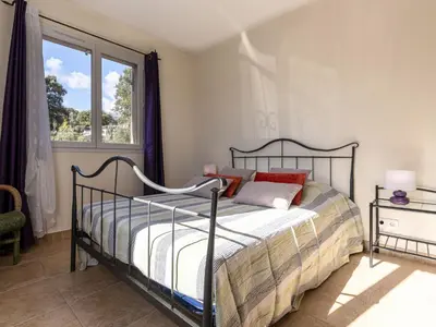 a bedroom with a bed and a window at Apartment Muratello by Interhome in Porto-Vecchio