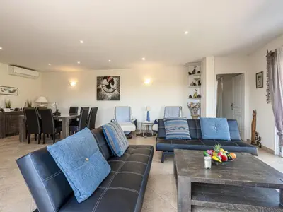 a living room with blue couches and a table at Apartment Muratello by Interhome in Porto-Vecchio