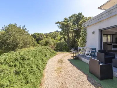 a patio of a house with chairs and a table at Apartment Paoli by Interhome in Porto-Vecchio