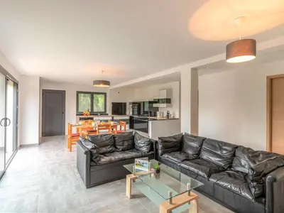 a living room with a leather couch and a table at Apartment Paoli by Interhome in Porto-Vecchio