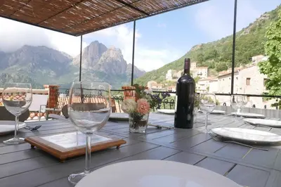 a table with wine glasses and a bottle of wine at I MONTI SIGNORI in Porto Ota