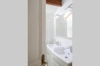 a white bathroom with a sink and a mirror at I MONTI SIGNORI in Porto Ota