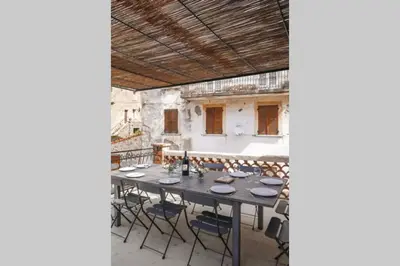 a long table with chairs sitting on a patio at I MONTI SIGNORI in Porto Ota