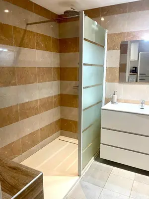 a bathroom with a shower and a sink at Bel appartement dans hameau calme in Bonifacio