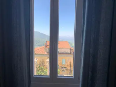 an open window with a view of a building at Casa Lisà in Sartène