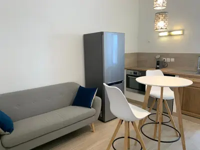 a living room with a couch and a table and a kitchen at Casa Lisà in Sartène