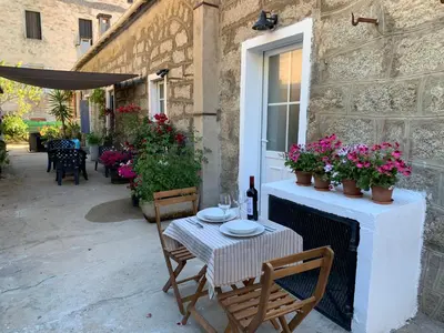 a table and chairs on a patio with flowers at Casa Lisà in Sartène