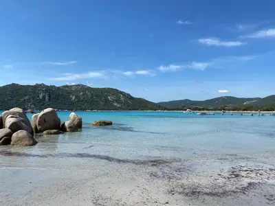 a beach with some rocks in the water at Appartement 2 pièces dans le centre historique de Porto Vecchio in Porto-Vecchio
