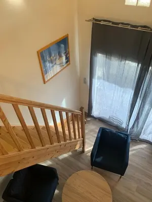 a room with a wooden staircase and a window at APPARTEMENT DUPLEX PORTICCIO Centre in Porticcio