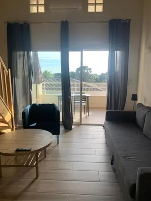 a living room with a couch and a table at APPARTEMENT DUPLEX PORTICCIO Centre in Porticcio
