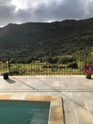 a swimming pool with a view of a mountain at Villa Capraghjese in Galeria