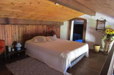 a bedroom with a large white bed in a room at Demi villa à 150m de la plage avec vue sur mer in Appietto