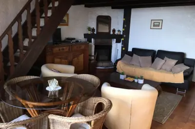 a living room with a couch and a table and chairs at Demi villa à 150m de la plage avec vue sur mer in Appietto