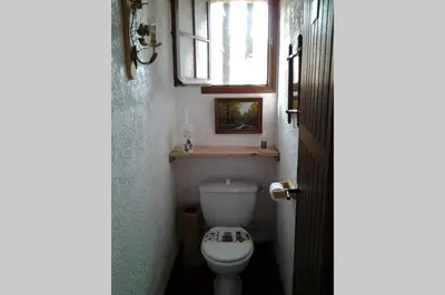 a small bathroom with a toilet and a window at Demi villa à 150m de la plage avec vue sur mer in Appietto