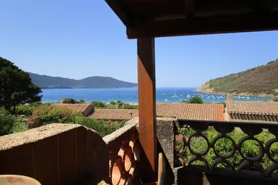 a view of the ocean from the balcony of a house at Demi villa à 150m de la plage avec vue sur mer in Appietto