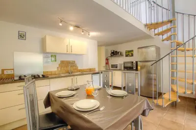 a kitchen with a table with two plates on it at Chez Pierre à Porto-Vecchio in Porto-Vecchio