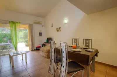 a living room with a table and a dining room at Chez Pierre à Porto-Vecchio in Porto-Vecchio