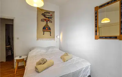 a bedroom with a white bed with towels on it at Lovely Home In Porticcio With Wifi in Porticcio