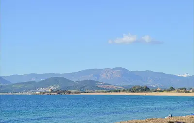 a large body of water with mountains in the background at Lovely Home In Porticcio With Wifi in Porticcio