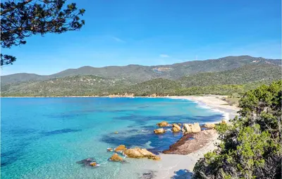 a view of a beach with rocks and the ocean at Lovely Home In Porticcio With Wifi in Porticcio