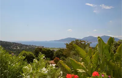 a view of the ocean from a garden with plants at Lovely Home In Porticcio With Wifi in Porticcio