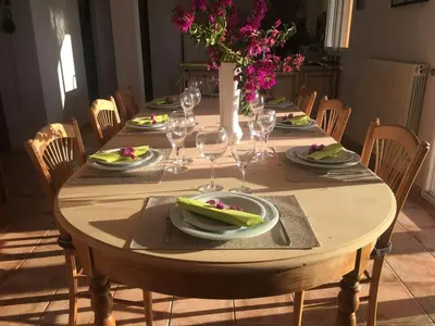 a wooden table with plates of food and wine glasses at PROPRIANO in Propriano