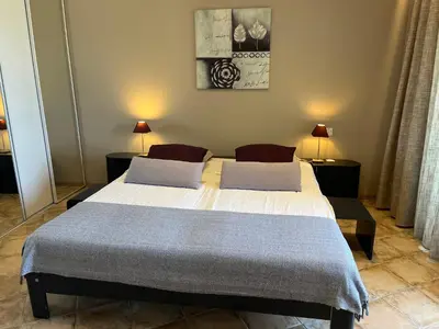a bedroom with a large bed with two pillows at PROPRIANO in Propriano