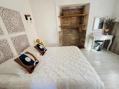 a bedroom with a large white bed with pillows on it at 