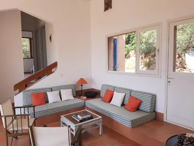 a living room with two couches and a table at Maison sur Palombaggia in Porto-Vecchio