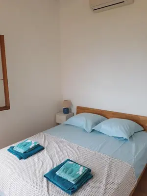 a bed with two towels on top of it at Maison sur Palombaggia in Porto-Vecchio