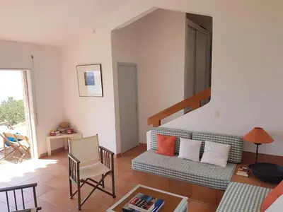 a living room with a couch and a table at Maison sur Palombaggia in Porto-Vecchio